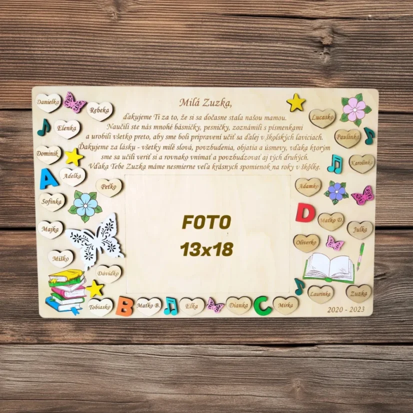 Drevená tabuľka s menami detí, gravírovaným textom, maľovanými výrezmi, v strede voľná plocha na fotku vo veľkosti 13x18cm..
