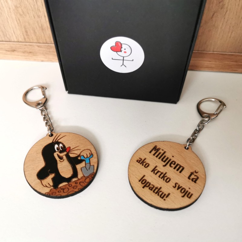 Drevená okrúhla kľúčenka s maľovaným krtkom a lopatkou, na druhej strane gravírovaný text "Milujem ťa ako krtko svoju lopatku!".
