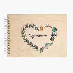 Drevený album s nápisom "Moje cestovanie", s gravírovanými a ručne maľovanými lístkami a motívmi výletov  - oheň, hory, stan, karavan, palma, vlny, mušľa, plážová obuv - všetko usporiadané do tvaru srdca.